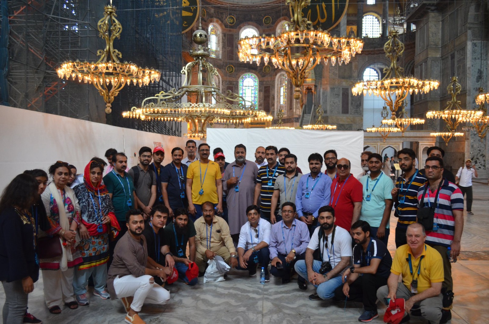 An IBEX group photographed inside Hagia Sophia in Istanbul, under the chandeliers